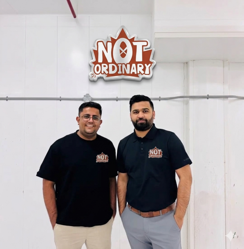 Two men posing with logo backdrop